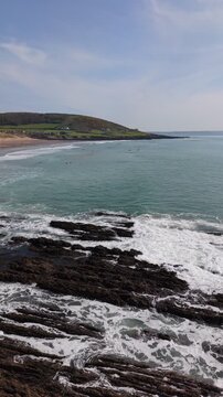 Aerial drone footage of Croyde Beach in North Devon, England, showcasing a sandy shoreline, rolling waves, and a popular surfing destination along the Atlantic coast