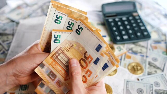 Man calculating money, monthly home expenses, taxes and bank account balance.