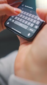 Female hands typing text on smartphone close-up.