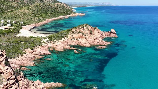 Aerial view of Su Sirboni Beach, Marina di Gairo, Sardinia, Italy. Turquoise sea, rugged red cliffs and hidden coves along the wild Ogliastra coastline
