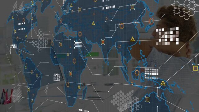 Man leaning back while monitor lighting revealing animated tech map overlaying desk monitoring data