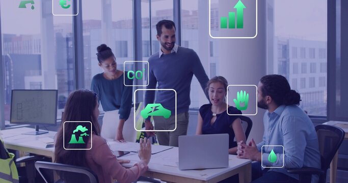 Collaborating 5-person team in business attire, pointing at laptop, docs, eco icons at office table