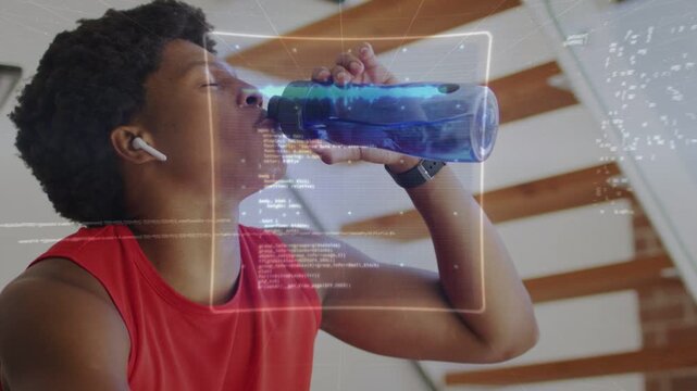 Fit man drinking from blue bottle during workout rest, HUD graphics tracking pulse and recovery