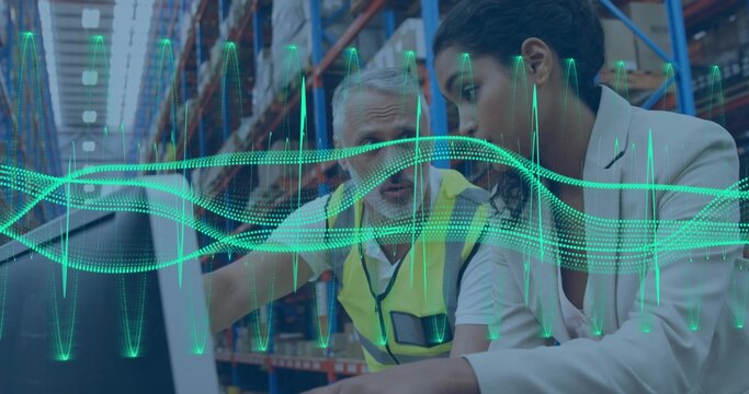 Pointing man in hi-vis vest, leaning woman in blazer checking laptop at warehouse with data overlay