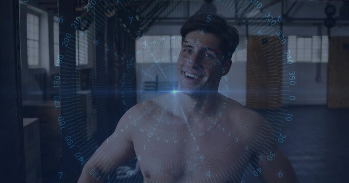 Smiling shirtless adult man posing in warehouse gym, translucent blue HUD, plyo boxes and metal rig