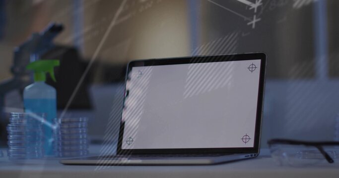 Displaying laptop with screen crosshairs at lab, green-nozzle spray, petri stack, glasses, board