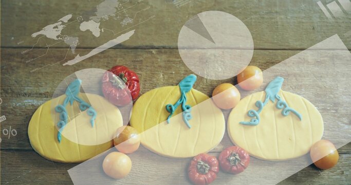 Showing three pumpkin cookies on plank with blue stems, tomatoes, red gourds, infographic overlays
