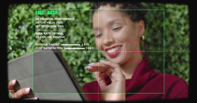 Tapping folio tablet, woman in red knit viewing EXEC_DASH HUD, red marker near cheek, plant-wall