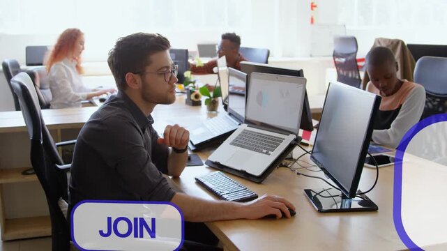 Man typing at desk in open-plan office, speech bubbles entering from right visualizing social media