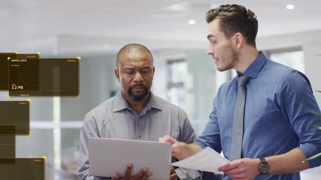 Analyst pointing to laptop and docs showing tech data senior reading laptop as yellow HUD stacking