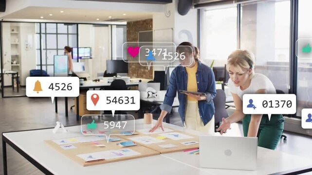 Two marketers tapping tablet sparking likes msgs peaking then settling around desk for engagement
