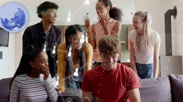 Man in red tee opening letter and reading, group celebrating, AR globe icon highlighting education