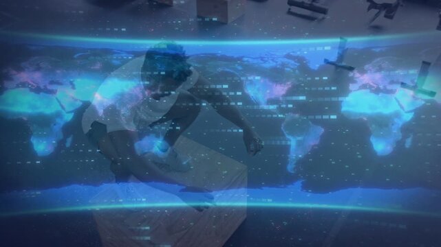 Worker reaching into box, kneeling, sorting parcels for shipping under blue map overlay masking man