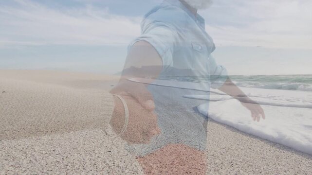 Man walking pebble shore pulling camera-hand looking back smiling ocean overlay marketing