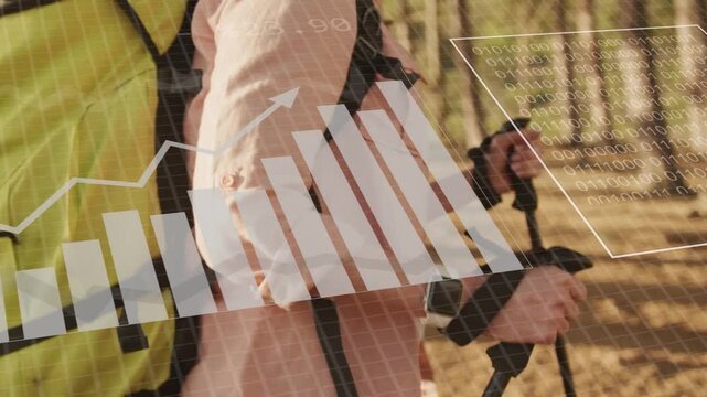 Woman hiker walking forest trail with poles while watch sending fitness data and HUD charts growing