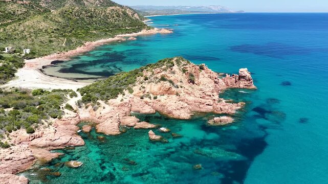 Aerial view of Su Sirboni Beach, Marina di Gairo, Sardinia, Italy. Turquoise sea, rugged red cliffs and hidden coves along the wild Ogliastra coastline
