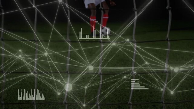 Keeper diving while striker pushing ball scoring goal under lights, sports data overlay tracking