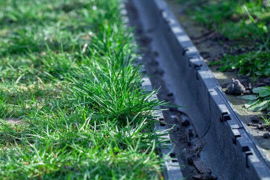 Garden drainage channel with green grass growing