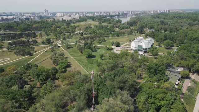Aerial forward drone flight over Usce Park in Belgrade, Serbia, on a sunny day.