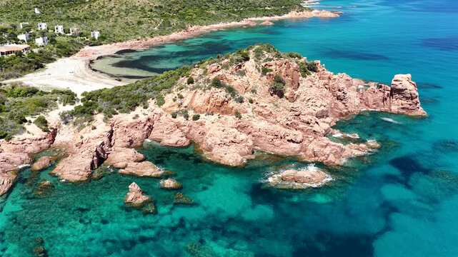 Aerial view of Su Sirboni Beach, Marina di Gairo, Sardinia, Italy. Turquoise sea, rugged red cliffs and hidden coves along the wild Ogliastra coastline