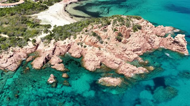 Aerial view of Su Sirboni Beach, Marina di Gairo, Sardinia, Italy. Turquoise sea, rugged red cliffs and hidden coves along the wild Ogliastra coastline