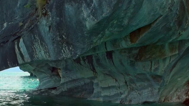 Journey into the serene Marble Caves of Patagonia. Smooth, artistic marble formations glow above tranquil turquoise waters, showcasing nature's sublime artistry and breathtaking beauty.
