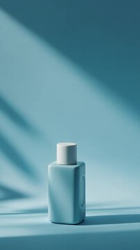 A small teal-colored bottle with a white cap sits on a matching surface, illuminated by a beam of light casting a shadow
