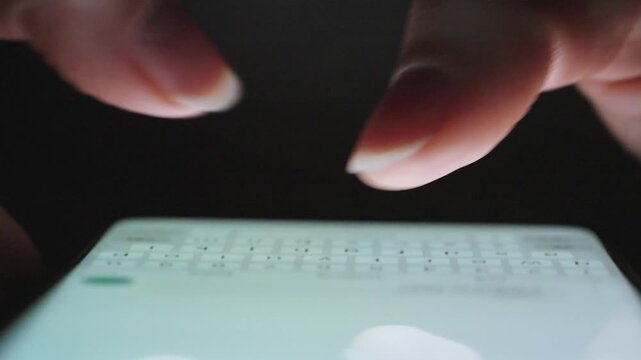 Female hands typing text on smartphone close-up.