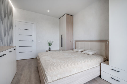 Interior of modern luxure bedroom in studio apartments or hotel with double master bed