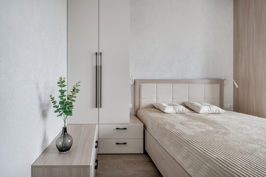 Interior of modern luxure bedroom in studio apartments or hotel with double master bed