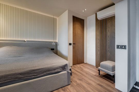 Interior of modern luxure bedroom in studio apartments or hotel with double master bed