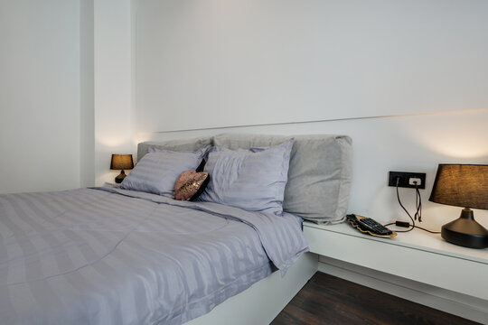 Interior of modern luxure bedroom in studio apartments or hotel with double master bed