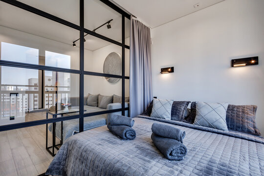 Interior of modern luxure bedroom in studio apartments or hotel with double master bed