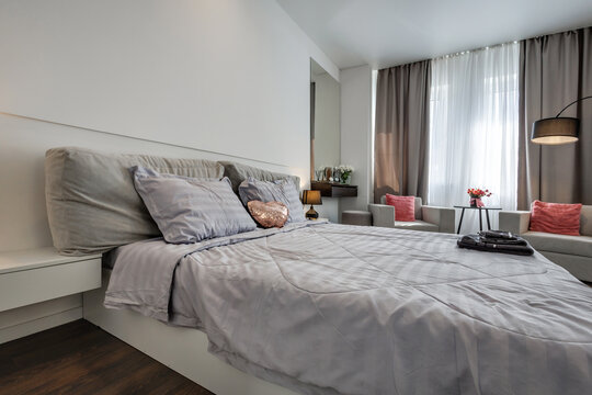 Interior of modern luxure bedroom in studio apartments or hotel with double master bed