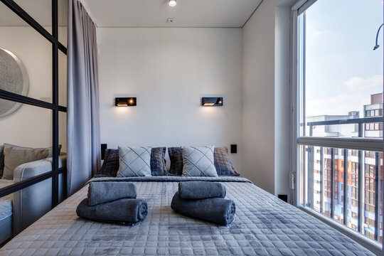 Interior of modern luxure bedroom in studio apartments or hotel with double master bed
