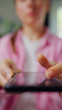 Woman scrolling through social media feeds on smartphone close up