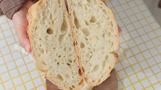 person is holding white bread in hands. homemade sourdough bread with crispy crust. Bakery products. yeast-free sourdough bread. healthy and healthy food. bakery. health care, gluten-free farm flour.