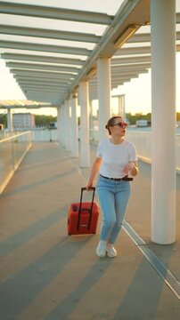 Caucasian woman pulling a suitcase and running, late for flight. 