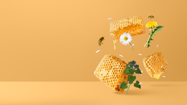 Wide banner with levitating honeycomb chunks, flying bees, honey drips, and wild spring flowers on a warm yellow background with copy space. Creative zero gravity food concept.