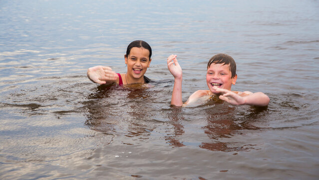 Children swim in a freshwater lake in hot weather