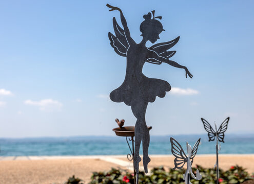 metal garden ornament in the shape of a dancing fairy