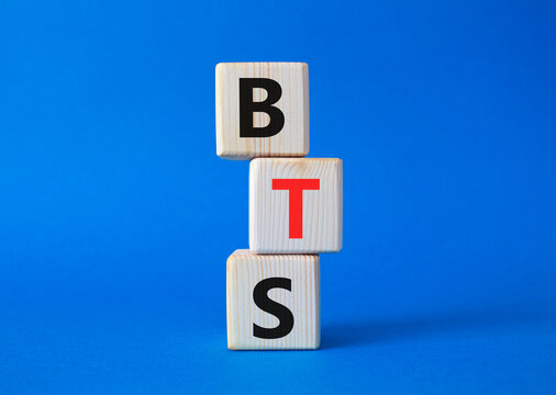 BTS symbol. Wooden cubes with word BTS. Beautiful blue background. BTS concept. Copy space.