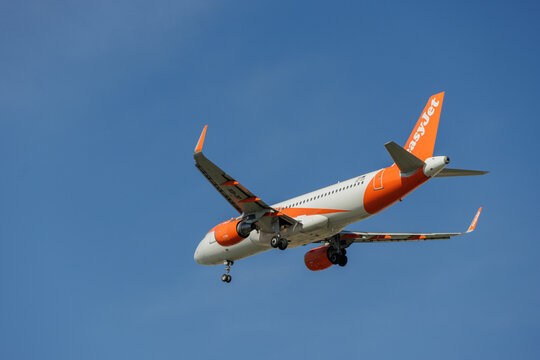 EasyJet Airbus A320 commercial airplane flying in blue sky