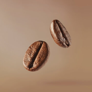 Flying roasted coffee beans isolated on beige background. Levitating aromatic arabica grains. Minimalist caffeine energy concept for espresso advertising.
