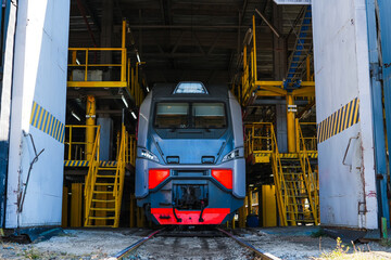 Naklejka premium Modern train in service depot for inspection.