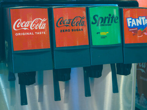 Self-Service Soda Fountain Machine with Coca-Cola, Sprite, and Fanta Dispensers Close-Up on April 25 2026 in Bangkok, Thailand.	
