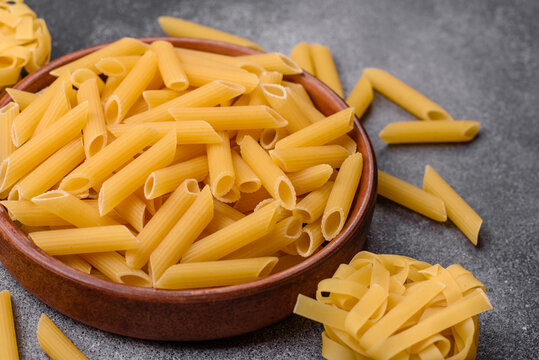 Italian uncooked dry penne regate pasta ready for cooking. Dry penne pasta