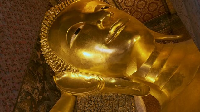 Close up view of Golden Big Buddha statue in Wat Pho Temple in Bangkok city, Thailand, Asia. Temple of the Reclining Buddha. Popular tourist landmark