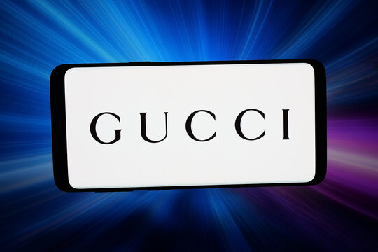Stuttgart, Germany - 04-16-2026: In this photo illustration, the logo of Italian fashion house Guccio Gucci S.p.A. is displayed on a smartphone in front of abstract background on computer screen.