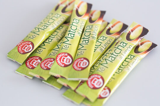 Alicante, Spain - April 25, 2026: Packets of Te Matcha green tea with lemon flavor arranged on a light background, featuring vibrant green and yellow packaging design